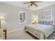 Well-lit bedroom featuring a queen bed, ceiling fan, and two windows at 2710 Laroche St, Edisto Beach, SC 29438