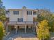 Stunning raised beach house with a large deck, sturdy pilings, convenient covered parking, and stairs at 2710 Laroche St, Edisto Beach, SC 29438