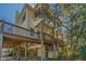 Angle looking up showing the 2-story home and wraparound deck. An outdoor kitchenette below the deck at 2710 Laroche St, Edisto Beach, SC 29438