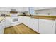 Bright kitchen with wood countertops, white cabinets, and appliances on wood-look vinyl flooring at 2710 Laroche St, Edisto Beach, SC 29438