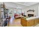 Comfortable living room with natural light, wood floors, a ceiling fan, and a cozy fireplace feature at 2710 Laroche St, Edisto Beach, SC 29438
