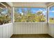 Covered porch with a view to the surrounding trees at 2710 Laroche St, Edisto Beach, SC 29438