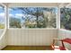 View from porch of lush trees and neighboring house on a bright, sunny day at 2710 Laroche St, Edisto Beach, SC 29438