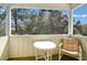 Comfortable porch with furniture that looks out at the green trees at 2710 Laroche St, Edisto Beach, SC 29438