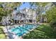 Stunning backyard with a private pool, sun loungers, and beautiful trees at 2863 Jasper Blvd, Sullivans Island, SC 29482