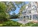 Lovely backyard with a private pool, brick paver patio, sun loungers, and beautiful trees at 2863 Jasper Blvd, Sullivans Island, SC 29482