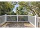 Balcony with white railings surrounded by mature trees offering shade and privacy at 2863 Jasper Blvd, Sullivans Island, SC 29482