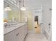 Bright bathroom with dual sinks, marble countertop, and access to the bedroom at 2863 Jasper Blvd, Sullivans Island, SC 29482