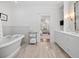 Bright bathroom features soaking tub, marble floors, and custom vanity with ample storage space at 2863 Jasper Blvd, Sullivans Island, SC 29482