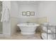 A serene bathroom space featuring a modern standalone bathtub and tiled walls at 2863 Jasper Blvd, Sullivans Island, SC 29482