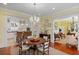 Dining room featuring kitchen view, modern chandelier, and hardwood floors at 2863 Jasper Blvd, Sullivans Island, SC 29482