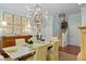 Formal dining room with a chandelier, wooden table, and yellow cushioned chairs at 2863 Jasper Blvd, Sullivans Island, SC 29482