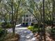 Charming two-story house with a long driveway, surrounded by mature trees offering privacy and curb appeal at 2863 Jasper Blvd, Sullivans Island, SC 29482