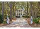 Charming two-story home with a long drive, lush trees, and a welcoming entrance at 2863 Jasper Blvd, Sullivans Island, SC 29482