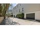 Exterior of the home displaying the driveway and garage doors along the side of the home at 2863 Jasper Blvd, Sullivans Island, SC 29482