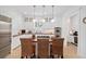 Well-lit kitchen with stainless steel appliances, wood countertops, island with cooktop, and custom white cabinetry at 2863 Jasper Blvd, Sullivans Island, SC 29482
