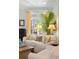 Comfortable living room with neutral tones, large windows, tropical plant and well-appointed furniture at 2863 Jasper Blvd, Sullivans Island, SC 29482