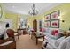 Bright living room features elegant chandelier, fireplace, hardwood floors, and stylish furnishings at 2863 Jasper Blvd, Sullivans Island, SC 29482