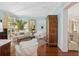 Open-concept living room with blue walls, hardwood floors, and stylish decor, seamlessly connecting to other spaces at 2863 Jasper Blvd, Sullivans Island, SC 29482