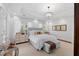 Bright main bedroom featuring a decorative chandelier, hardwood floors, and lots of natural light at 2863 Jasper Blvd, Sullivans Island, SC 29482