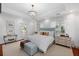 Bright main bedroom featuring a chandelier, hardwood floors, bench, and a door to a porch at 2863 Jasper Blvd, Sullivans Island, SC 29482