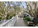 Spacious deck with comfortable outdoor seating and views of mature trees at 2863 Jasper Blvd, Sullivans Island, SC 29482