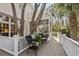 Comfortable outdoor seating area on a spacious deck with lush greenery at 2863 Jasper Blvd, Sullivans Island, SC 29482
