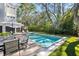 Backyard pool featuring a large in-ground pool, comfortable lounge seating, lush green surroundings and a tree house at 2863 Jasper Blvd, Sullivans Island, SC 29482