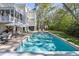 Backyard pool area featuring a large pool, various seating arrangements, and lush greenery at 2863 Jasper Blvd, Sullivans Island, SC 29482