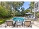 Backyard pool with lounge chairs and ample seating for relaxation with lush green surroundings at 2863 Jasper Blvd, Sullivans Island, SC 29482