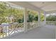 Relax on this charming porch overlooking lush greenery and mature trees at 2863 Jasper Blvd, Sullivans Island, SC 29482