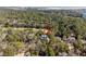 Lush trees surround a home with a grey roof near a golf course in this aerial shot at 2928 Baywood Dr, Seabrook Island, SC 29455