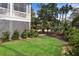 Lush backyard with green lawn, mature trees, and a patio, offering a serene outdoor space for relaxation at 2928 Baywood Dr, Seabrook Island, SC 29455