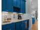 Charming bar area with dark blue cabinetry, a wine rack, and marble countertops at 2928 Baywood Dr, Seabrook Island, SC 29455