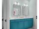 Modern bathroom with stylish teal vanity, dual sinks, and modern fixtures at 2928 Baywood Dr, Seabrook Island, SC 29455