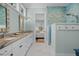 Bathroom showcasing a double vanity with sinks, a shower with tile, and an open doorway to the bedroom at 2928 Baywood Dr, Seabrook Island, SC 29455