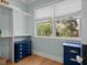 Bright closet featuring custom organizers, hardwood floors, and natural light with windows overlooking a green yard at 2928 Baywood Dr, Seabrook Island, SC 29455