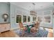 Light-filled dining room with stylish furnishings and a beautiful rug under a modern chandelier at 2928 Baywood Dr, Seabrook Island, SC 29455