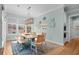 Airy dining area features stylish decor, a wooden table and bench and coastal decorations at 2928 Baywood Dr, Seabrook Island, SC 29455