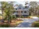 Charming two-story home with a manicured lawn, elegant porch, and a welcoming driveway at 2928 Baywood Dr, Seabrook Island, SC 29455