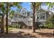Back of house featuring porch, deck, stairs and large backyard at 2928 Baywood Dr, Seabrook Island, SC 29455