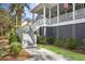 Side view of house with stairs to enter porch, along with green grass and landscaping at 2928 Baywood Dr, Seabrook Island, SC 29455
