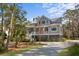 Beautiful gray two-story home with a covered porch and well-manicured lawn at 2928 Baywood Dr, Seabrook Island, SC 29455