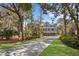 Stately two-story home with gray siding, covered porch, and lush landscaping at 2928 Baywood Dr, Seabrook Island, SC 29455