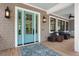 Inviting porch with a blue front door, outdoor seating, and overhead fan at 2928 Baywood Dr, Seabrook Island, SC 29455