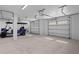 Spacious two-car garage with a golf cart, white walls, bright lighting, and overhead storage at 2928 Baywood Dr, Seabrook Island, SC 29455