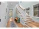 Hallway with wooden stairs and an accent bench underneath natural lighting from a window at 2928 Baywood Dr, Seabrook Island, SC 29455