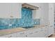 Detailed view of the kitchen featuring blue tile backsplash, modern appliances, and custom cabinetry at 2928 Baywood Dr, Seabrook Island, SC 29455