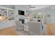 Cozy living room featuring fireplace, built-in bookshelves, and backyard view at 2928 Baywood Dr, Seabrook Island, SC 29455