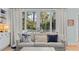 Comfortable living room couch with decorative pillows, offering a cozy spot to relax and enjoy views through the windows at 2928 Baywood Dr, Seabrook Island, SC 29455